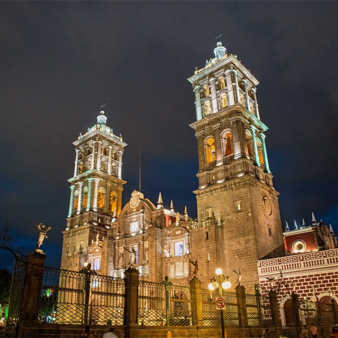 Authentic Mexico: Front view of the majestic Cathedral Basilica of Puebla (Basílica Catedral Metropolitana de Nuestra Señora de la Purísima Concepción), highlighting its ornate façade, towering bell towers, and colonial architectural beauty.