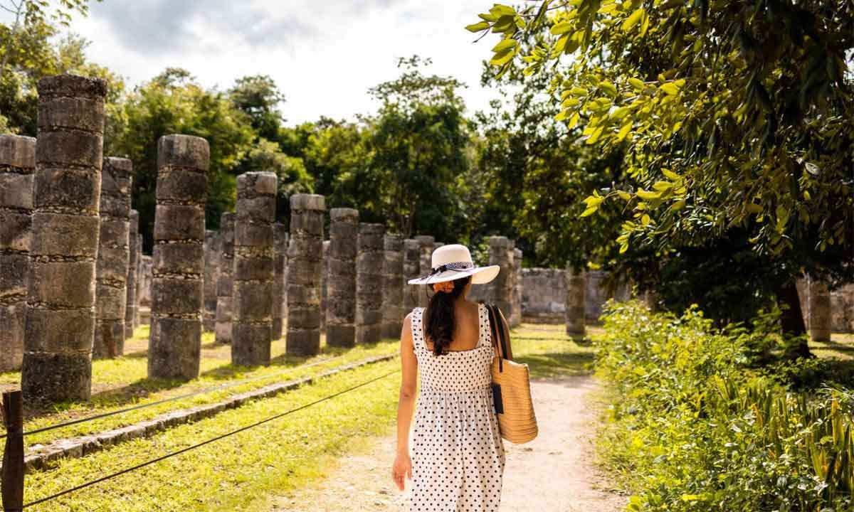 Traveler exploring ancient stone columns at a Mexico archaeological site during a private Mexico journey focused on cultural heritage.