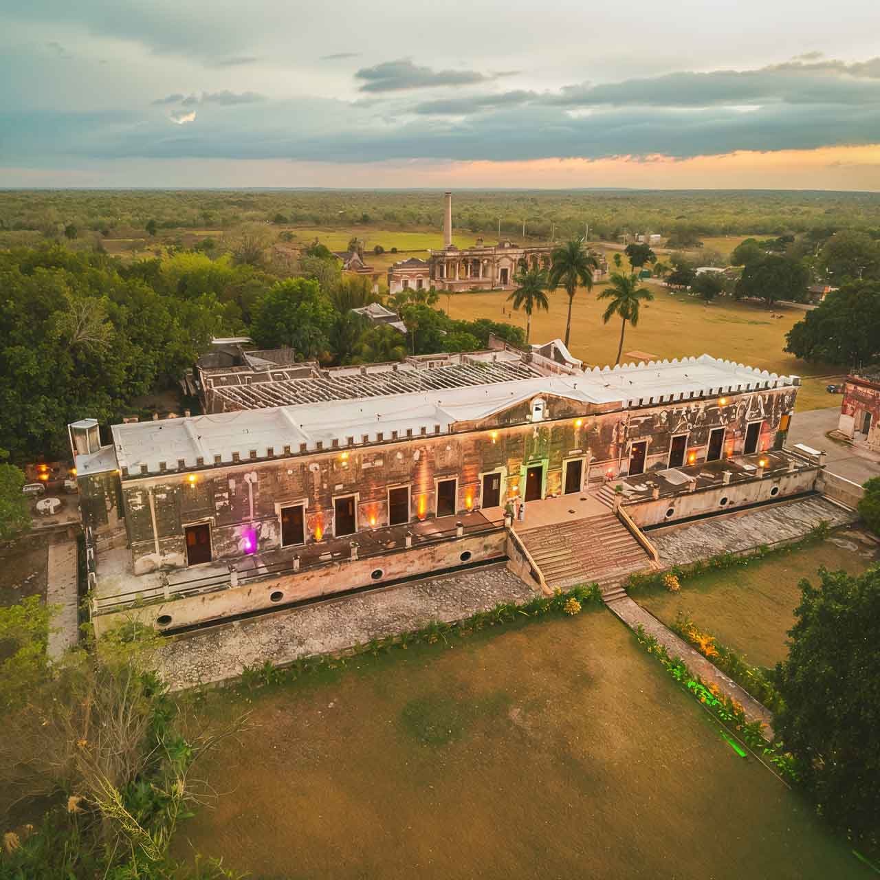 Yucatan-Haciendas - authentictravelmexico.com Historic Yucatán hacienda surrounded by tropical landscape, offering context for private journeys through Mérida, haciendas, and regional history.