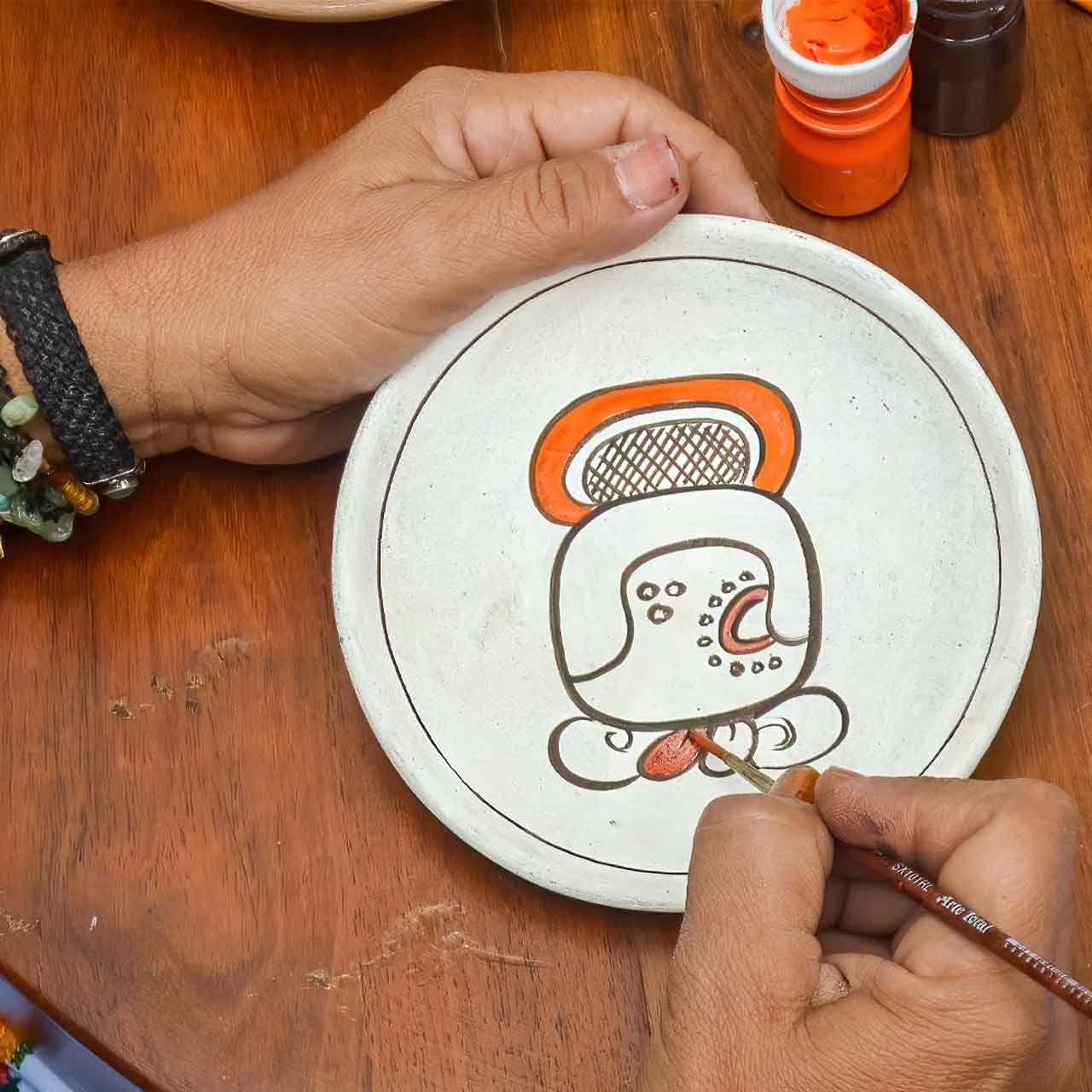 Yucatan-Hands-On-Experiences - authentictravelmexico.com Artisan painting a ceramic plate in Yucatán during a hands-on cultural experience arranged as part of a private Yucatán journey.